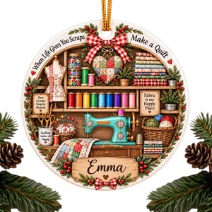 May include: A round ceramic ornament featuring a sewing room scene with a teal sewing machine, spools of thread, fabric stacks, and a mannequin. The text reads When Life Gives You Scraps Make a Quilt, Fabric is my Happy Place, and Emma.