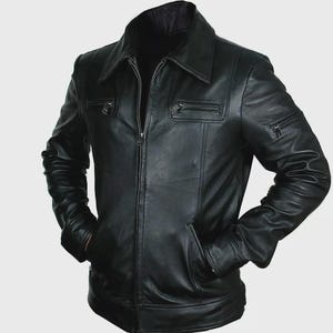 May include: A black leather jacket with a collared neckline and a front zipper closure. The jacket features multiple pockets, including two chest pockets with zippers and two hand pockets. The sleeves have a slight gathered detail at the shoulders.
