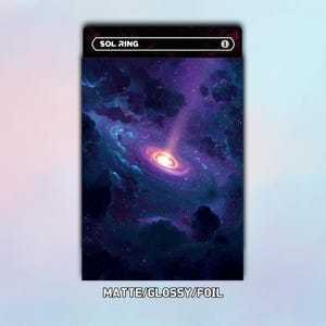 May include: A card with a cosmic design featuring a swirling galaxy in shades of purple, blue, and white. The card has the text "SOL RING" at the top and "MATTE/GLOSSY/FOIL" at the bottom.