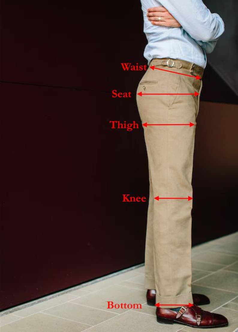 May include: Khaki-colored pants with a belt, shown with measurement labels for waist, seat, thigh, knee, and bottom. The pants are paired with brown leather shoes. The image is a side view of the pants.