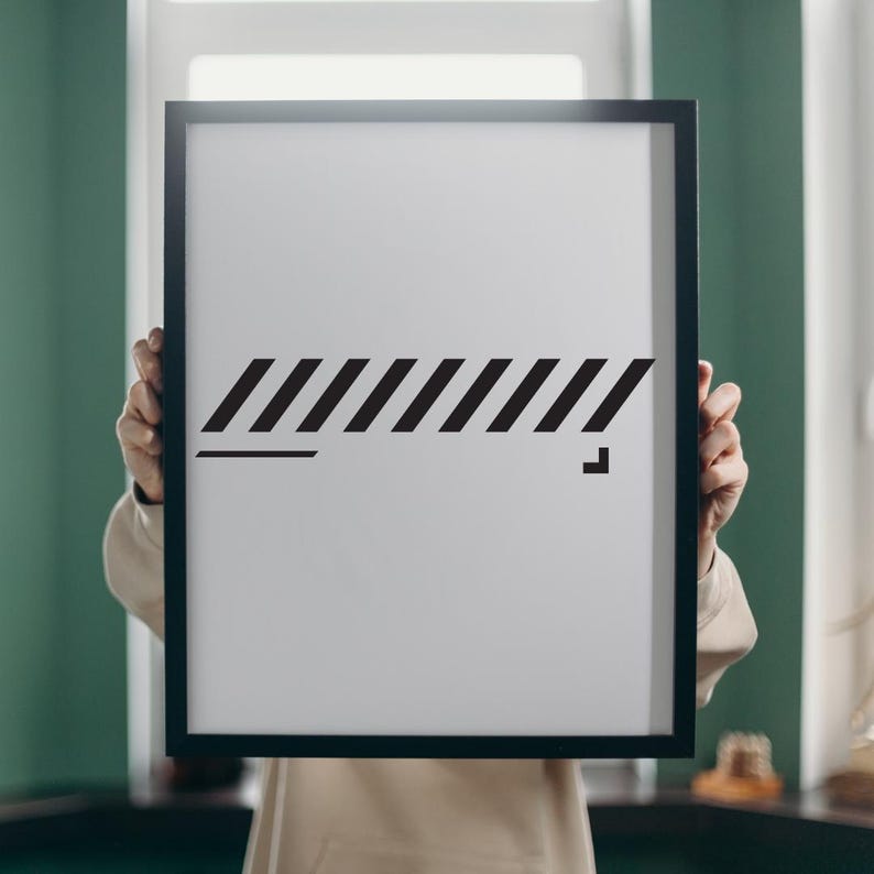 May include: A framed white print with a black geometric design. The artwork features a series of diagonal lines and a horizontal line, with a small square at the end. The frame is black.