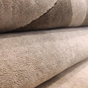 May include: A white ceramic mug with a black handle and the text "But First, Coffee" in a black, handwritten-style font. The mug is on a white surface.