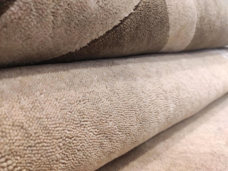 May include: A white ceramic mug with a black handle and the text "But First, Coffee" in a black, handwritten-style font. The mug is on a white surface.