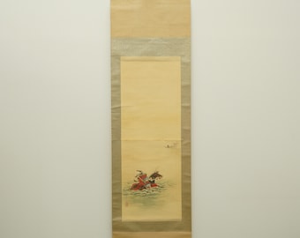May include: A vintage Japanese scroll painting featuring a scene of figures on horseback in a body of water. The artwork is rendered in shades of red, brown, and blue, with a cream-colored background and a wooden dowel at the bottom.