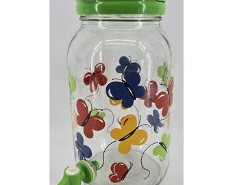 Jarra de vidrio vintage Y2K para té solar con mariposas multicolores y tapa verde.