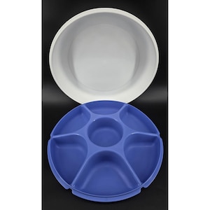May include: Two-piece serving set. The top piece is a large, white, round bowl. The bottom piece is a blue, divided serving tray with six sections. The tray is round with a central well and curved dividers.