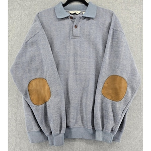 May include: A light blue and white striped sweatshirt with a light blue collar and brown elbow patches. The sweatshirt has a button-up collar and ribbed cuffs and hem.