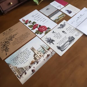 May include: A collection of stationery items including postcards, envelopes, and small cards featuring literary quotes, botanical illustrations, and vintage-style architectural drawings. The items display text such as You live in beauty, Prose & Post Society, and various excerpts from Henry David Thoreau and Henry James.