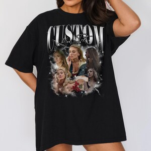 May include: Black t-shirt with the word "CUSTOM" in a silver, stylized font. Below the text is a collage of women's portraits. The words "All Your Text" are below the word "CUSTOM".
