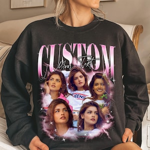 May include: Black sweatshirt with a custom design. The design features a collage of images of a person, with the word "CUSTOM" in pink and white text above the images. The words "Your Text" are also visible.