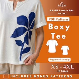 May include: A white short-sleeved boxy tee with a blue floral design. The shirt has a V-neck and rolled-up sleeves. The image includes text that says "Boxy Tee" and "XS - 4XL".