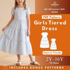 May include: A young girl wearing a light blue and white gingham tiered dress. The dress has short sleeves and a flowing skirt. The image also includes text that reads "Girls Tiered Dress" and "2Y-16Y 16 Sizes".