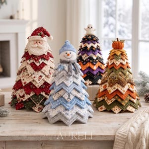 May include: Four decorative fabric trees featuring seasonal themes. One is a red Santa Claus, one is a blue snowman, one is a purple and black ghost-topped tree, and one is an orange and green pumpkin-topped tree, all with layered chevron patterns.