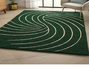 May include: A green area rug with a cream-colored, swirling pattern. The rug is rectangular and has a plush texture. The design features curved lines that create a flowing, abstract motif, suitable for living rooms or bedrooms.