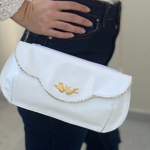 White leather clutch with golden birds