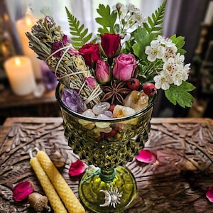 May include: A white ceramic mug with a black handle and the text "But First, Coffee" in a bold, black font. The mug is sitting on a wooden surface. The mug is approximately 4 inches tall.