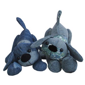 May include: Two denim dog plushies, one with a floral pattern on its chest and the other with a solid denim chest. Both have black button eyes and noses.