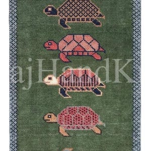May include: A rectangular green rug featuring six turtles arranged in a vertical column. Each turtle displays a unique geometric pattern on its shell in colors including orange, blue, pink, and dark red. The rug has a blue patterned border.
