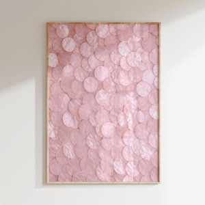 May include: A rectangular wall art piece featuring a light pink, semi-transparent circular disc pattern layered in a scale-like arrangement. The artwork is encased in a thin, light-toned wooden frame, creating a textured and uniform visual effect.