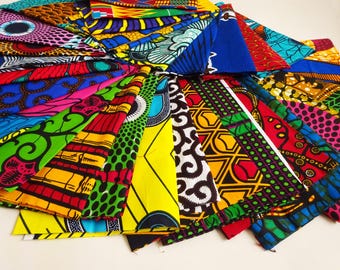 May include: A collection of vibrantly patterned African fabric triangles in various colors, including blue, red, yellow, and green. The fabric features geometric and floral designs, arranged in a circular fan shape.