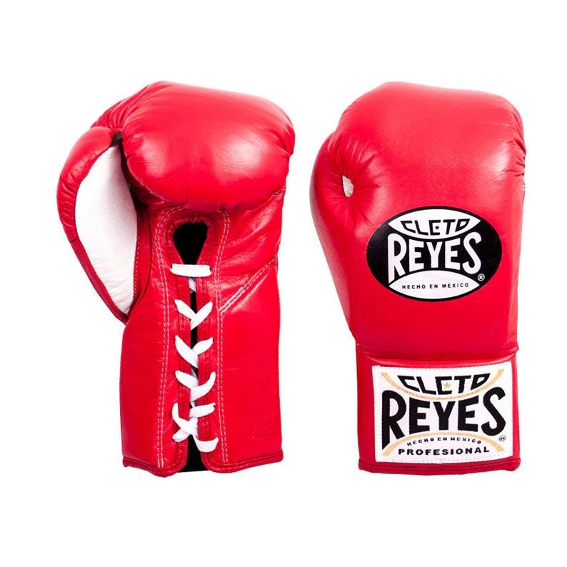 May include: Pair of red leather boxing gloves with white laces. The gloves have the brand name "CLETO REYES" printed on the wrist area and the top of the glove. The gloves are made in Mexico.