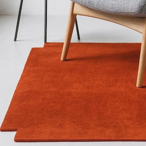 May include: A set of three ceramic mugs with a speckled, matte finish. The mugs are in shades of cream, light gray, and dark gray. Each mug has a simple, minimalist design and a rounded handle.