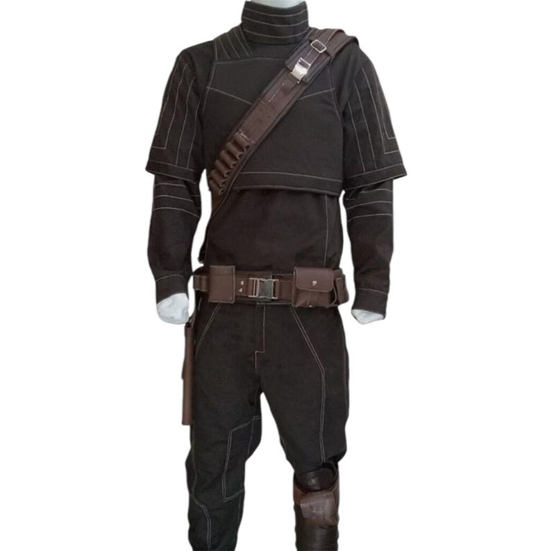 May include: A dark brown costume with white stitching, featuring a high-collared top, long sleeves, and matching pants. The outfit includes a brown belt with pouches, a shoulder strap, and knee pads. A holster is attached to the leg.