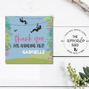 May include: A blue and green thank you card with a cartoon image of two people ziplining through a jungle. The card says "thank you for hanging out! - Gabrielle".