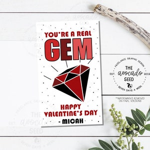 Puede incluir: Una tarjeta de San Valentín con una ilustración de una gema roja y el texto "You're a real GEM. Happy Valentine's Day - Micah".
