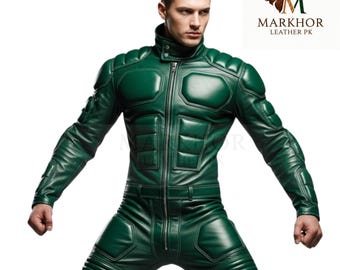 May include: A full-body, emerald green leather jumpsuit with a high collar and a front zipper. The suit features padded sections on the shoulders, chest, and knees. The Markhor Leather PK logo is visible in the upper right corner.