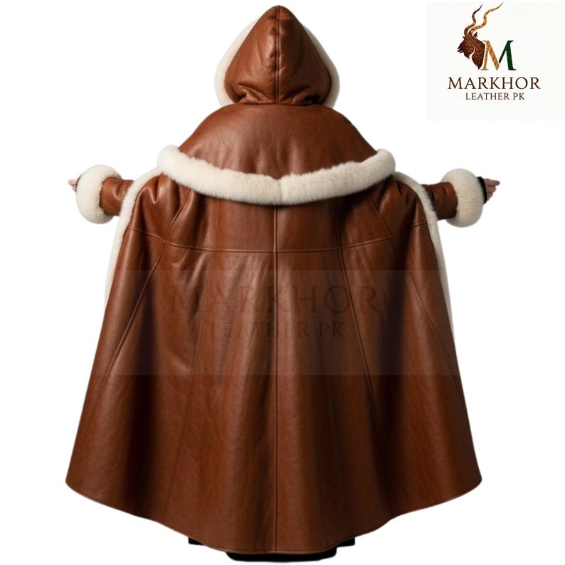 May include: A brown leather hooded cape with white fur trim around the hood and cuffs. The cape is made of a smooth, dark brown leather and has a flowing design. The back view shows the cape's full length and details.