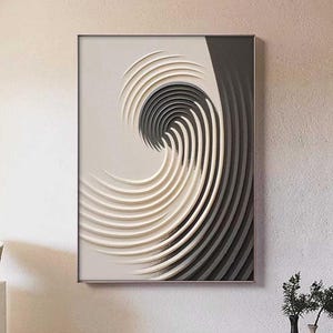 May include: Abstract wall art featuring a layered design in shades of white, gray, and black, creating a swirling, wave-like pattern. The artwork is framed and mounted on a neutral-colored wall, adding a modern touch to the space.