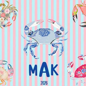 May include: A whimsical design featuring five illustrated crabs in various colors and patterns against a striped background of pink and light blue. The word "MAK" and the year "2026" are displayed in blue.