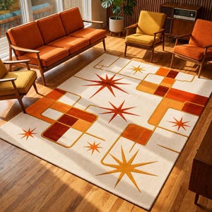 May include: A rectangular area rug featuring a cream-coloured background with a geometric pattern of orange and yellow starbursts, interconnected lines, and solid rectangular blocks in varying shades of orange, brown, and gold.