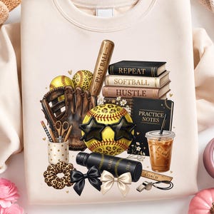 May include: A beige crewneck sweatshirt featuring a graphic of a brown leather softball glove, two yellow leopard-print softballs, a stack of books labelled Repeat, Softball, Hustle, a notebook labelled Practice Notes, a coffee cup, and a water bottle.
