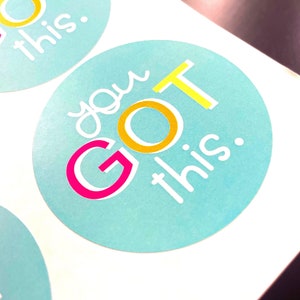 May include: Two turquoise blue round stickers with the text "you GOT this." in white, yellow, and pink lettering.