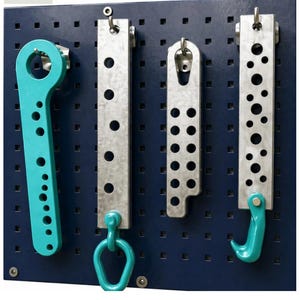 May include: Four-piece set of metal auto body tools, including a wrench, hooks, and brackets, in silver and teal. The tools are mounted on a dark blue pegboard. The number "28" and "4 PCS" are displayed in the image.