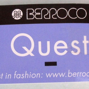 May include: A purple and black tag with the text "Berroco Quest" and the website "www.berroco.com". The tag reads "First in fashion".