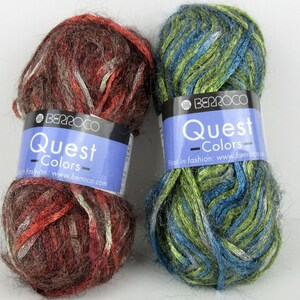 May include: Two skeins of yarn in the Berroco Quest Colors line. One skein is a mix of brown, red, and white, and the other is a mix of green, blue, and silver.