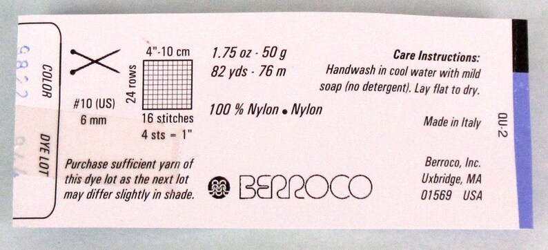May include: A white label with black text and a logo for Berroco yarn. The label includes information about the yarn, such as the fibre content, weight, yardage, and care instructions. The label also includes a gauge swatch and needle size recommendations.