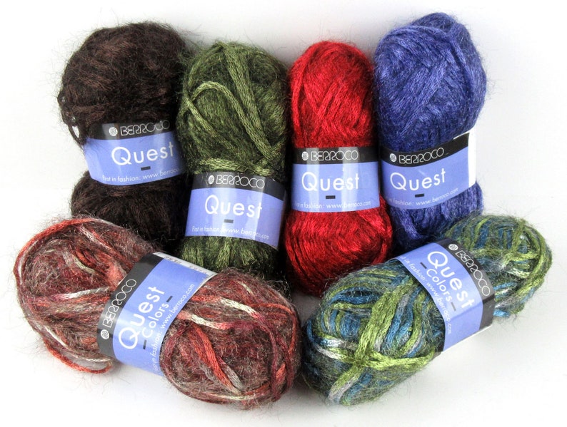May include: Assortment of six skeins of yarn in various colours, including brown, green, red, blue, and multi-coloured. Each skein has a label that reads "Berroco Quest - Colors - For a fabulous knit, www.berroco.com".