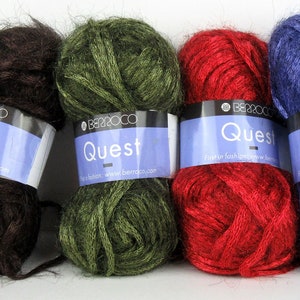 May include: Four skeins of yarn in different colours: brown, green, red, and blue. Each skein has a label that reads "Quest" and "Berroco".