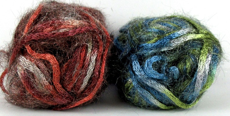 May include: Two balls of yarn, one brown with red and white stripes, the other green with blue and white stripes.