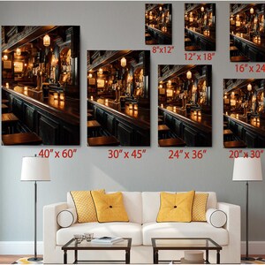 The image is a living room with a white sofa and a coffee table, and there are multiple framed photographs of a bar scene displayed on the wall above the sofa.