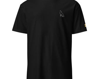 May include: Black t-shirt with a small white outline of a howling wolf on the upper left chest. The shirt has short sleeves and a tag on the right sleeve.
