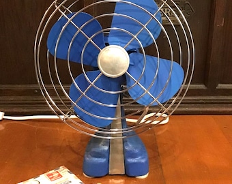 Medium blue 2 tone single speed table or desk fan. Classic 1950s style open cage design, compact and quiet. Inline on off switch.