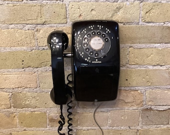 Updated dial wall phone, Black shiny finish American Electric Co. Works with modern systems. Very good condition. With modern ring tone.