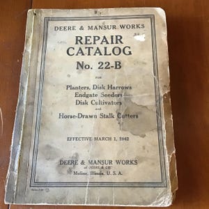 May include: A vintage Deere & Mansur Works Repair Catalog No. 22-B, with text for Planters, Disk Harrows, Endgate Seeders, Disk Cultivators, and Horse-Drawn Stalk Cutters. The catalog is dated March 1, 1942, and is from Moline, Illinois, U.S.A.