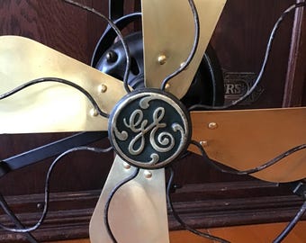 Black brass blade oscillating all metal fan, two speed desk fan, good air flow, open cage design General Electric Co. made in USA.