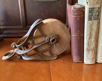Squirrel cage pulley, wood wheel and cast iron barn pulley. Large metal and wood, used with rope for hoisting, lifting, moving, farm work.